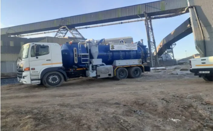 AB Sambane branded truck at an industrial plant with conveyor structures